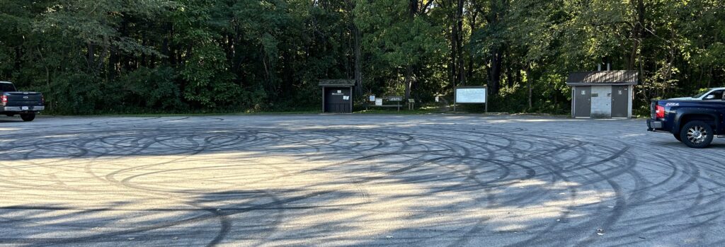 An empty parking lot in the shade.