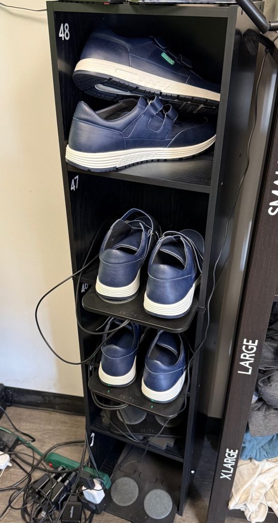 Several blue shoes are stacked in a shoe holder.