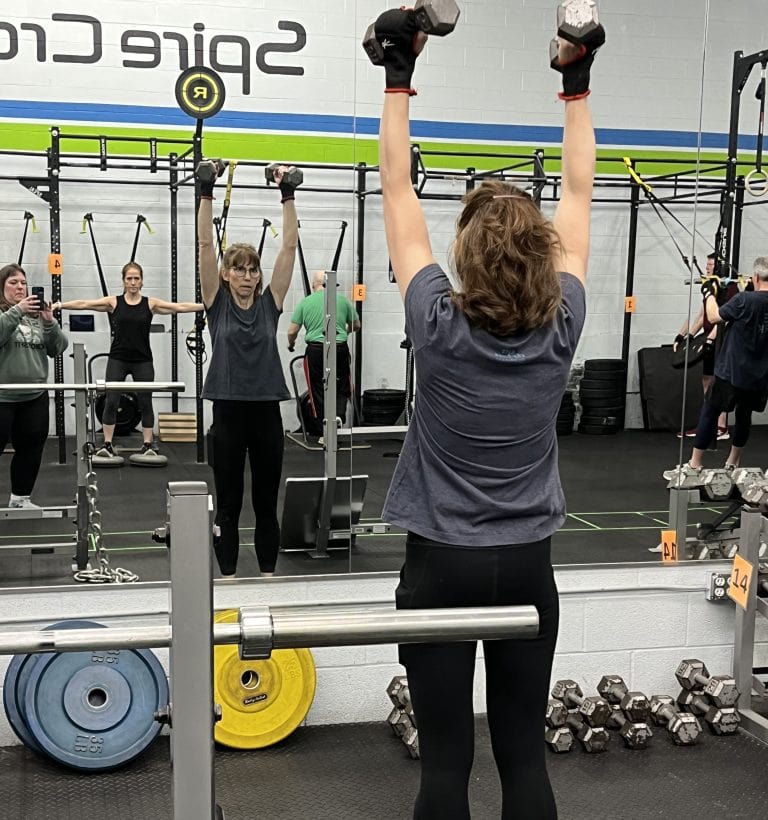 A woman lifts weights.