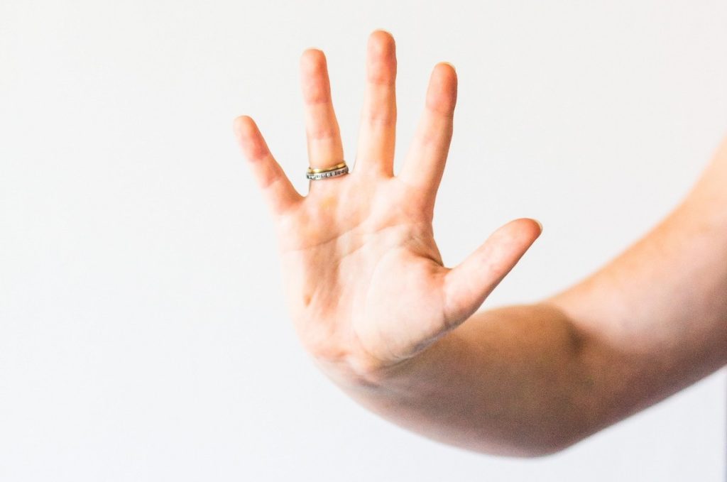 A woman's had is stretched out like a high-five.