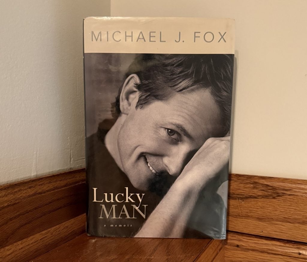 Michael J. Fox smiles on the front cover of his book "Lucky Man."