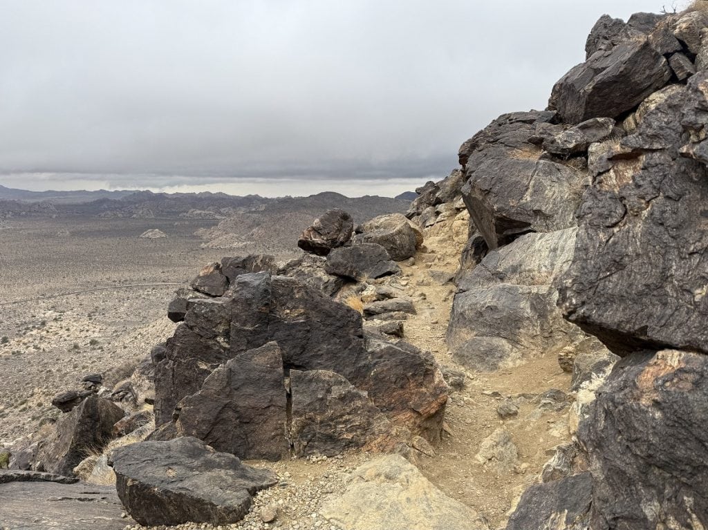 A rocky trail goes downward.