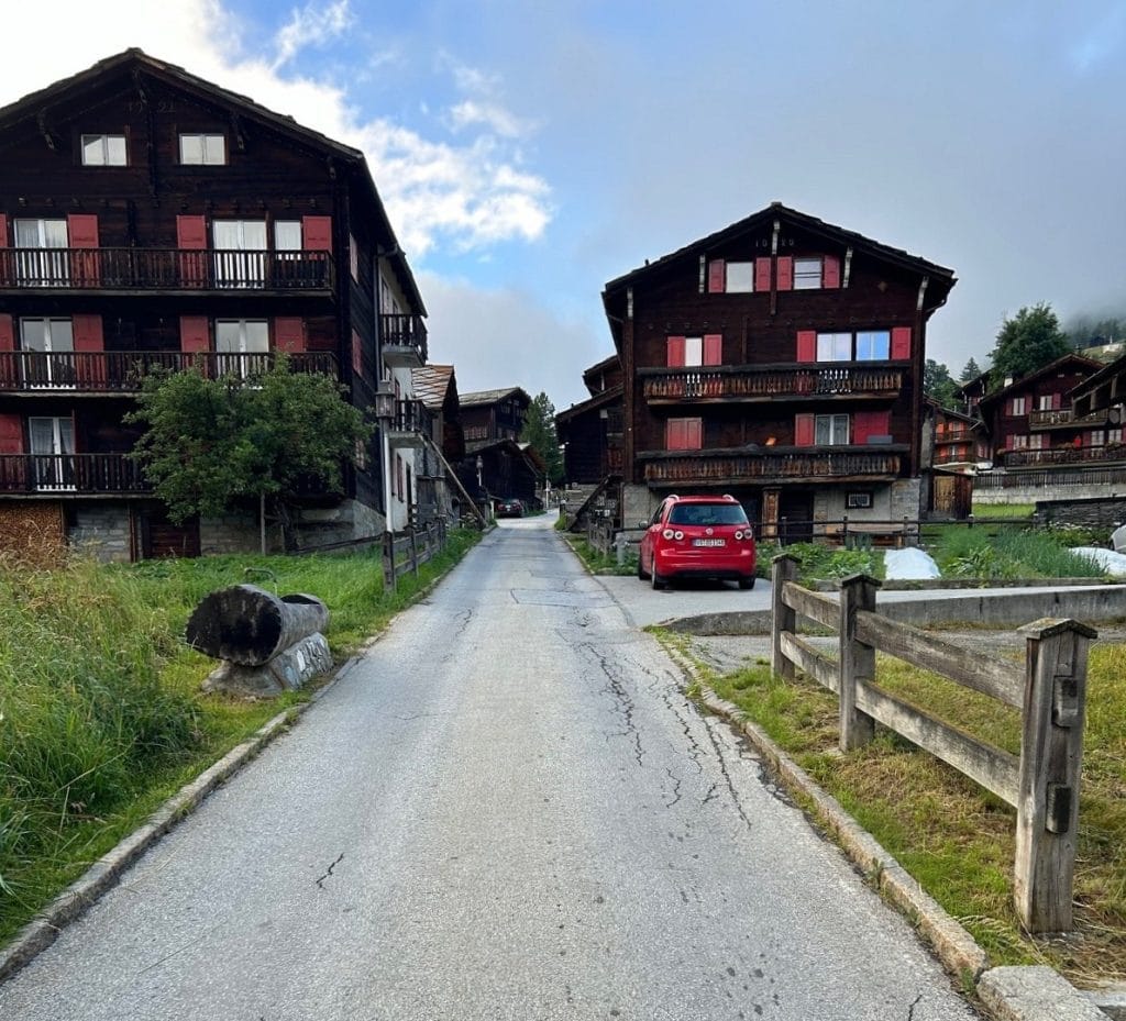 Two boarding houses are shown on either side of a small road.