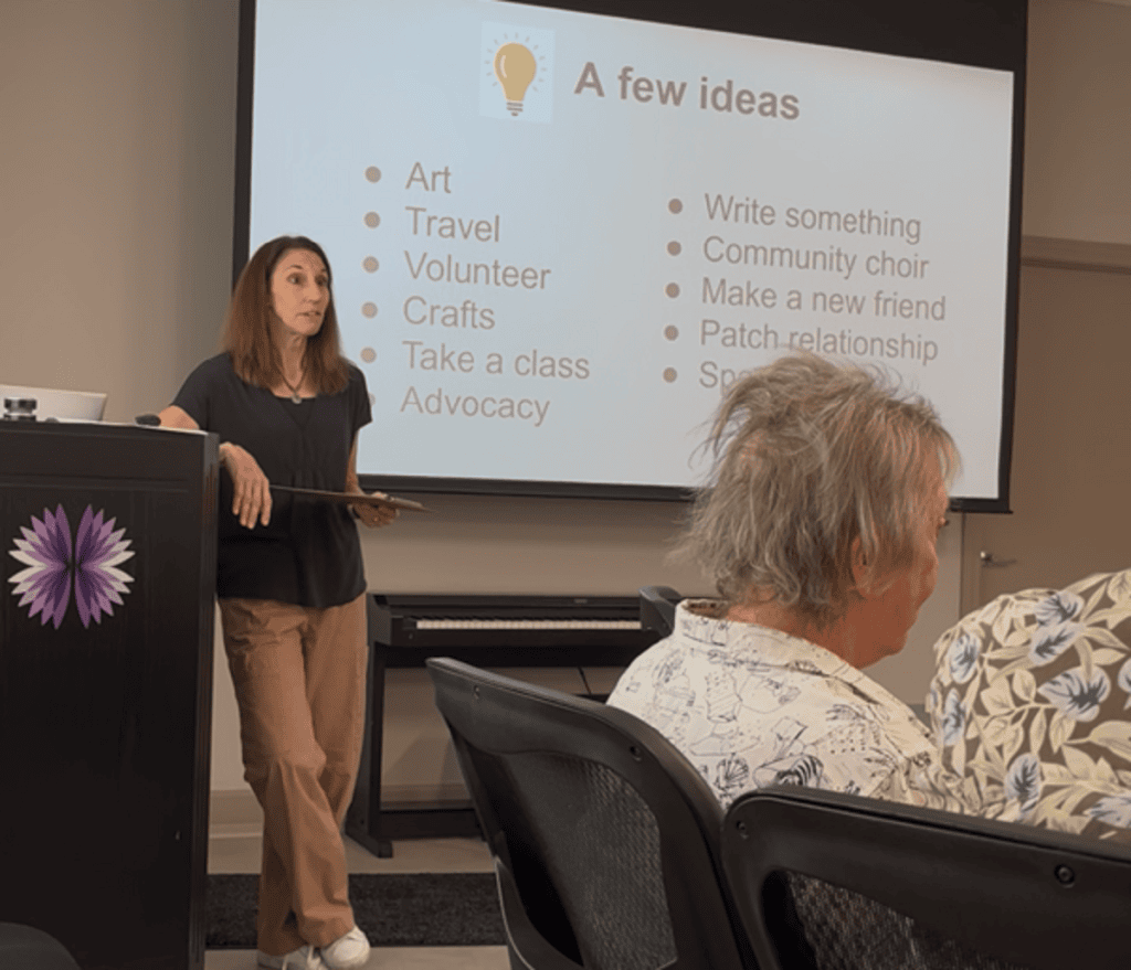 A woman next to a podium  shows a power point slid to a group of people.