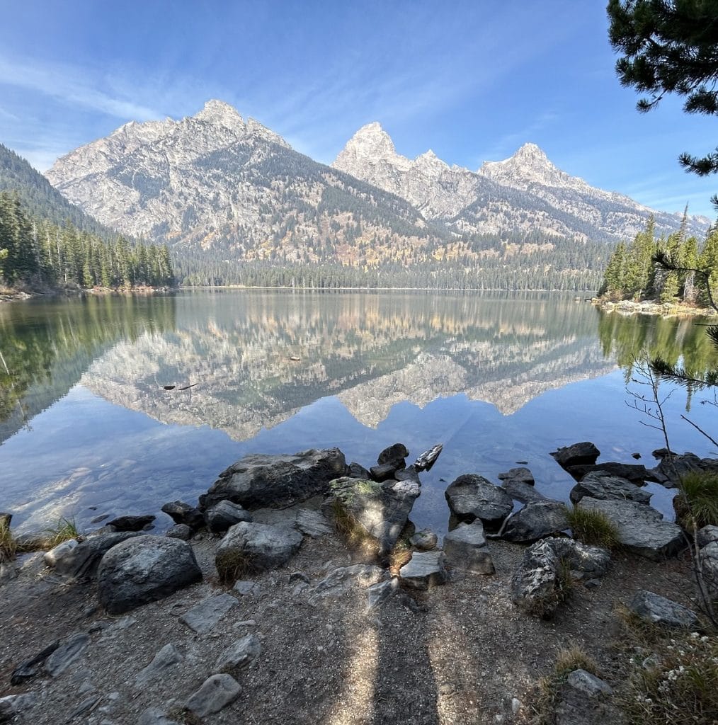 The three peaks are reflected off Taggart Lake.