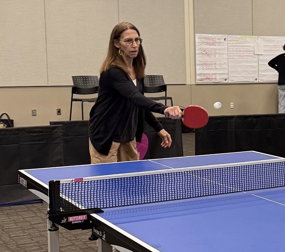 A woman plays ping pong.