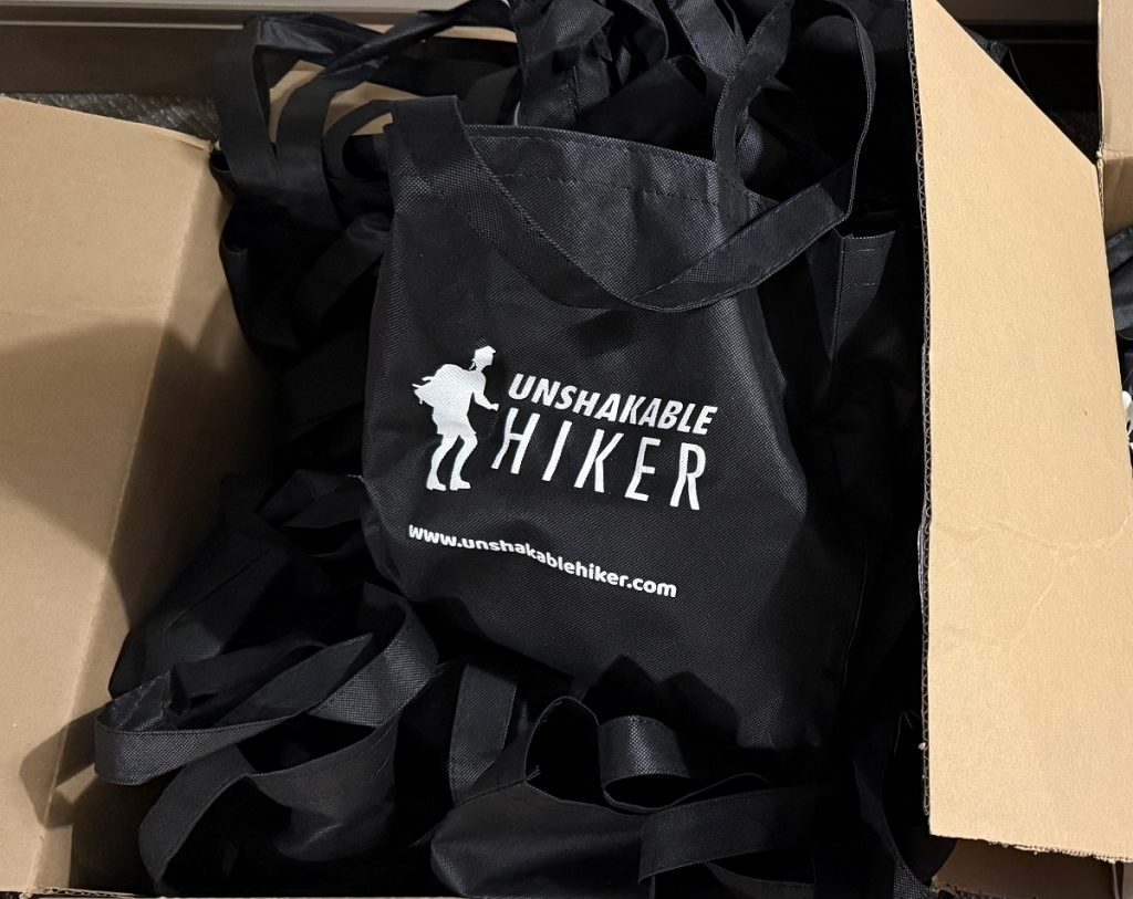 A box os swag bags have a logo on them.
