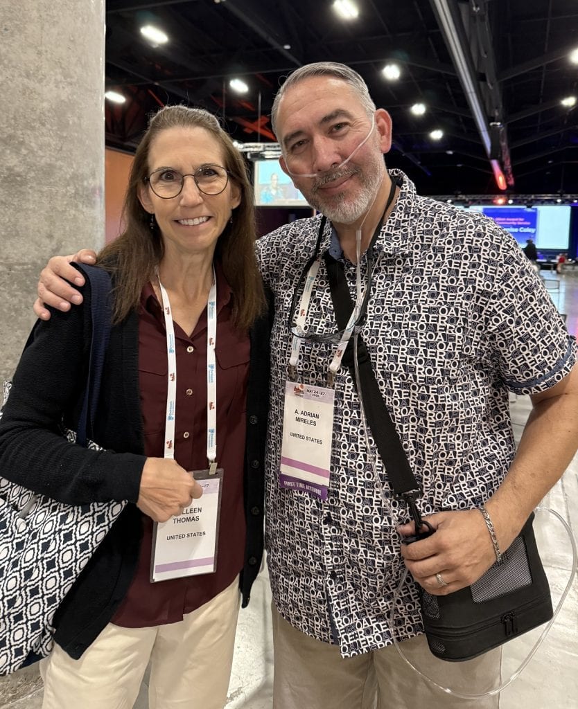 A man and woman smile for the camera.