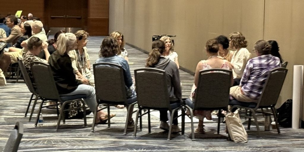 A group of women chat during a roundtable session.