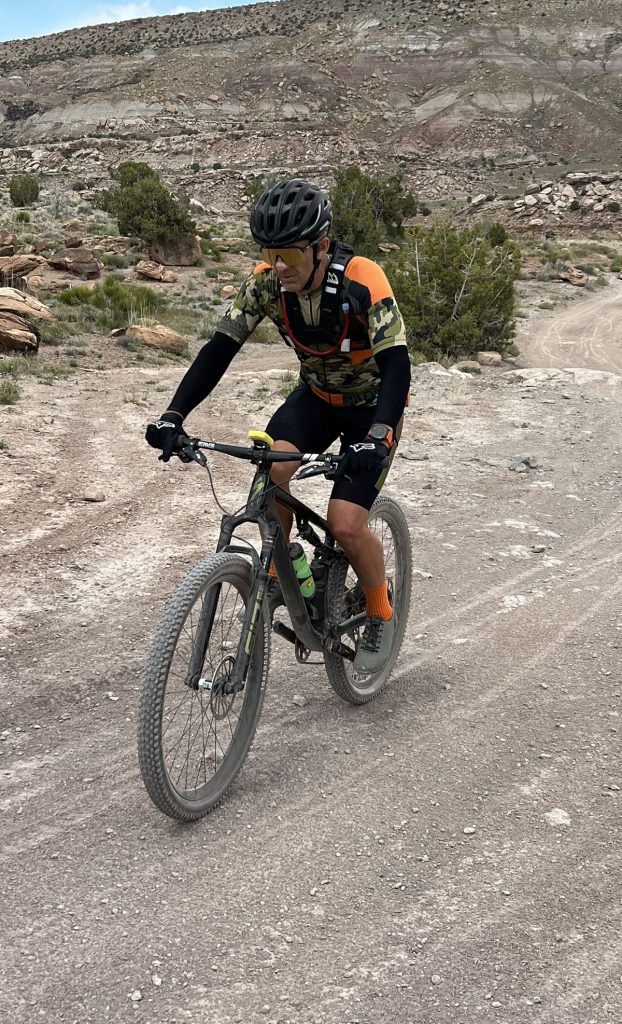A man on a road is bicyling.