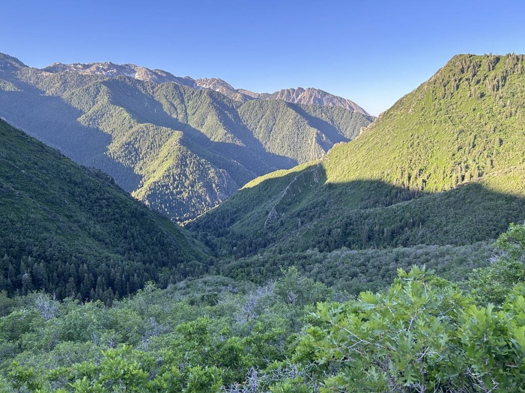 A mountain range is shown with morning shade over a portion of it.