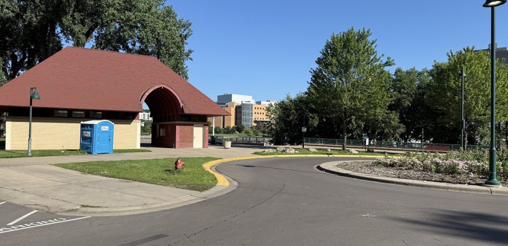 A parking area has a building next to it.