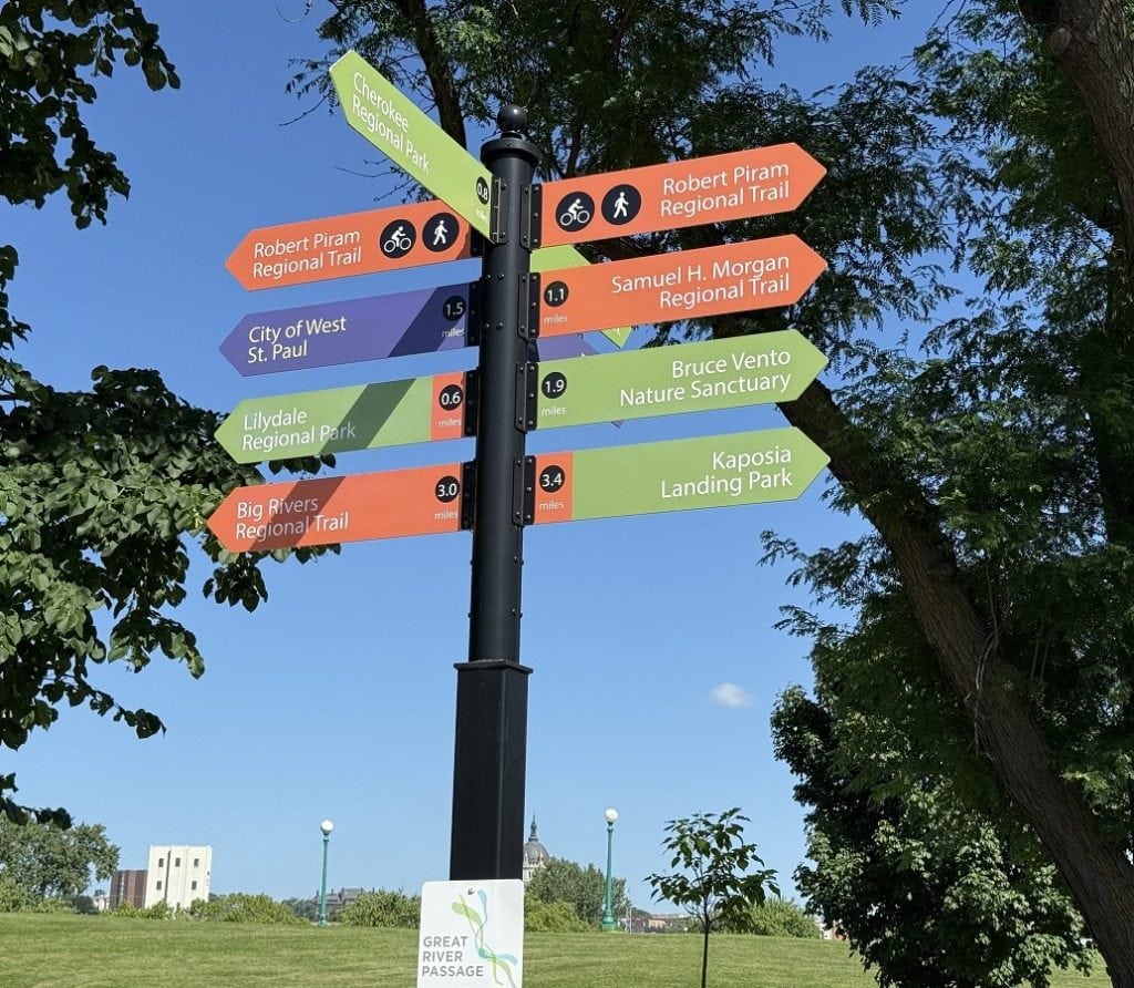 A colorful trail sign points in different directions.